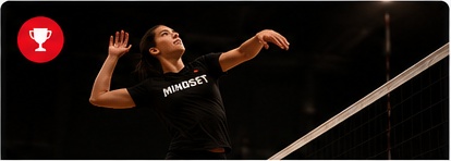 Volleyball player attacking at the net